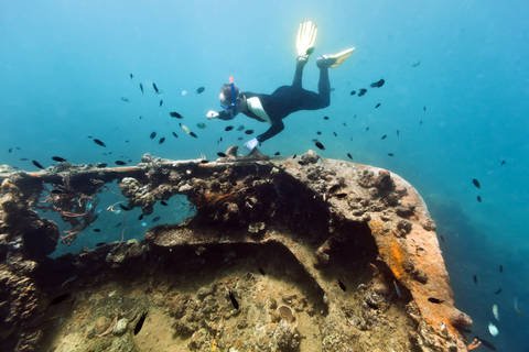 Diver explores gunboat shipwreck at Lusong Island near Coron
