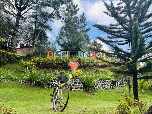 Reel Place Bukidnon's park entrance with rainbow letters and a decorative bicycle.